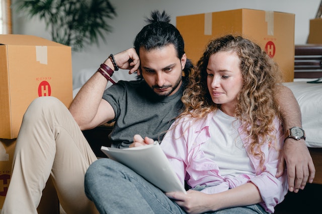 a couple reading their checklist before moving