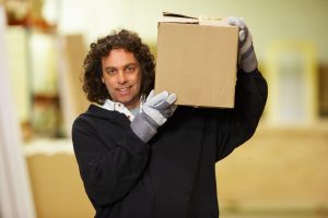 Removalists at work - man carrying a box